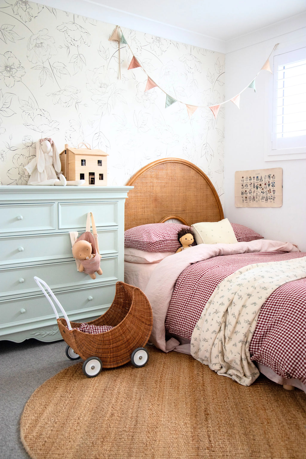 Round Jute rug in a Children's bedroom with a bed, dresser, and toys.