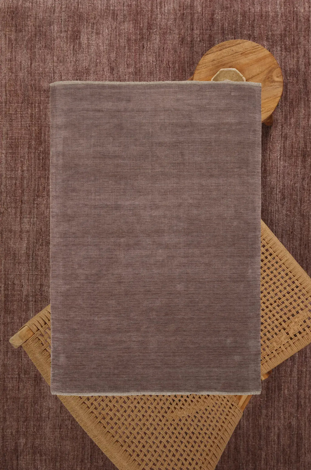 Brown textured rug on a wooden floor